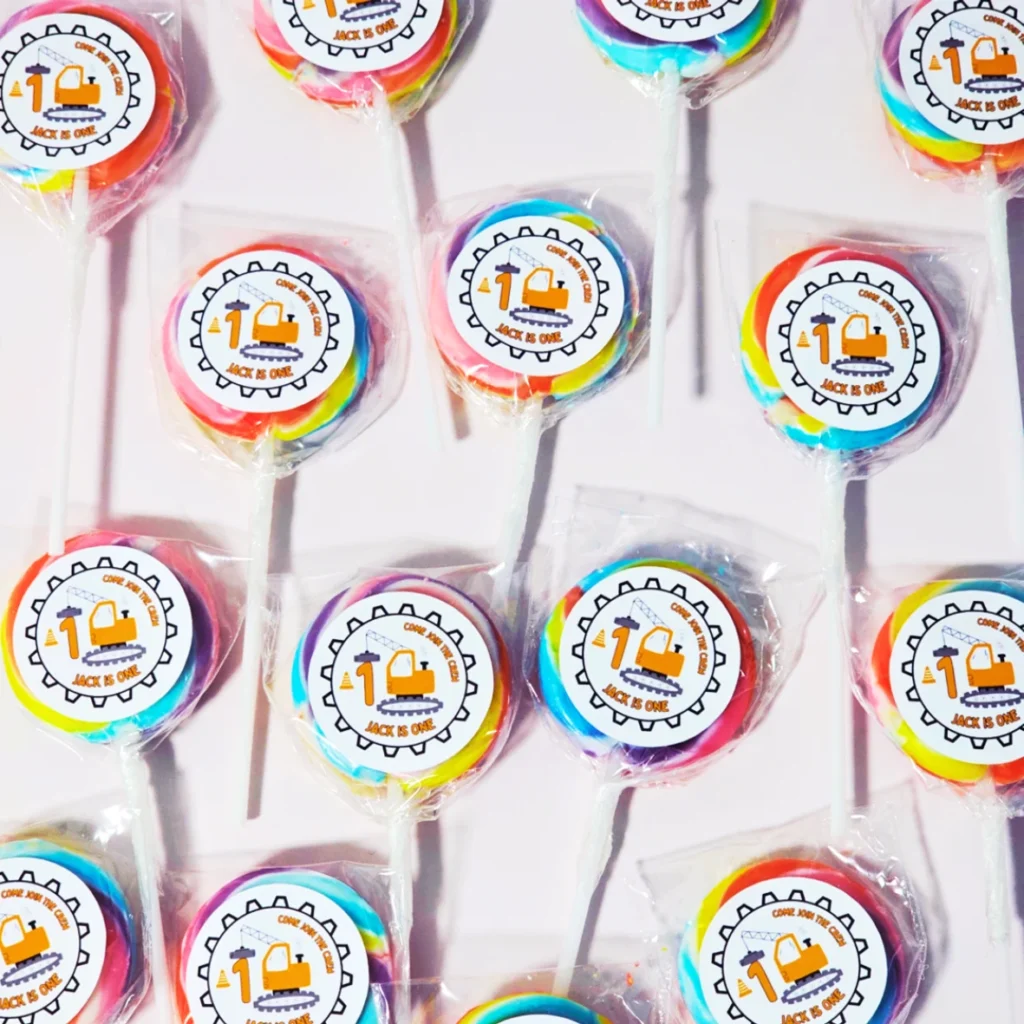 Construction themed rainbow swirly lollipop party favours with digger design for a kids birthday party.