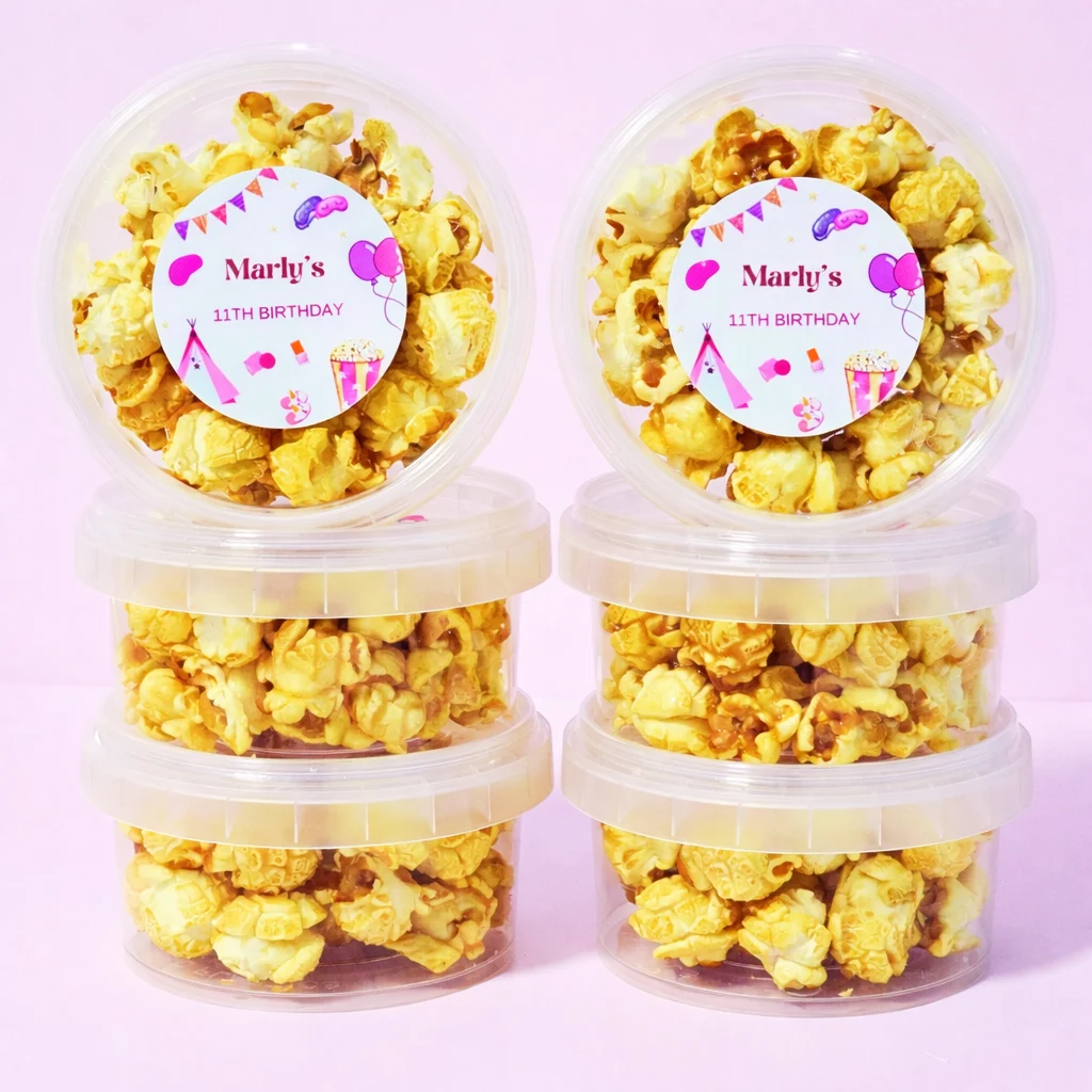 Personalised caramel popcorn tubs with sleepover birthday labels