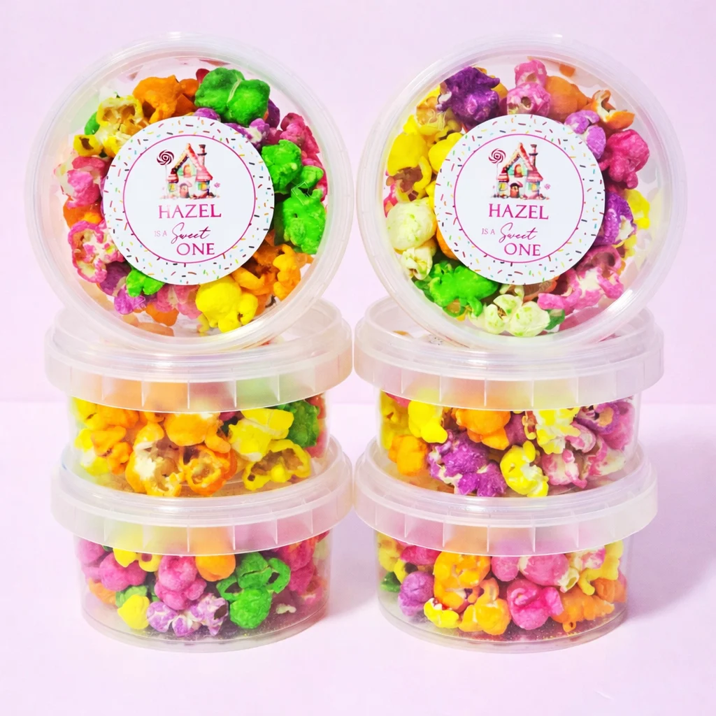 Personalised rainbow popcorn tubs with sweet one first birthday labels
