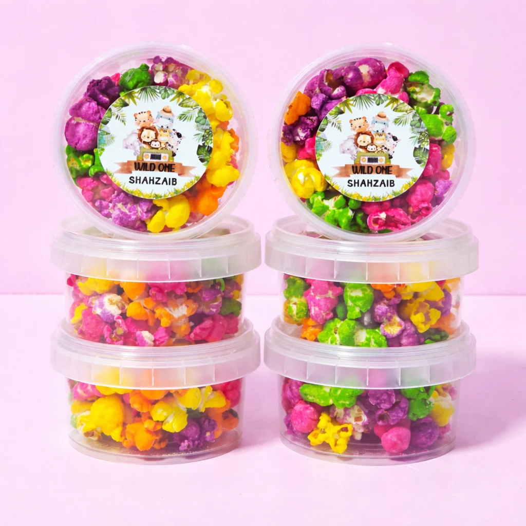 Rainbow popcorn tubs with personalised labels for party orders
