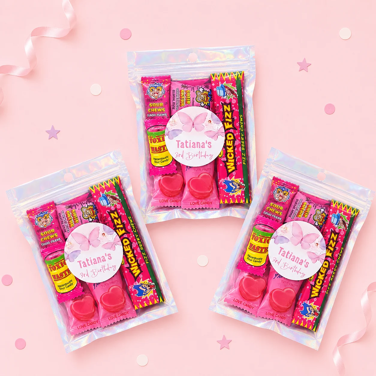 Butterfly personalised lolly bags prefilled with assorted lollies and finished with custom pink butterfly labels for a 3rd birthday