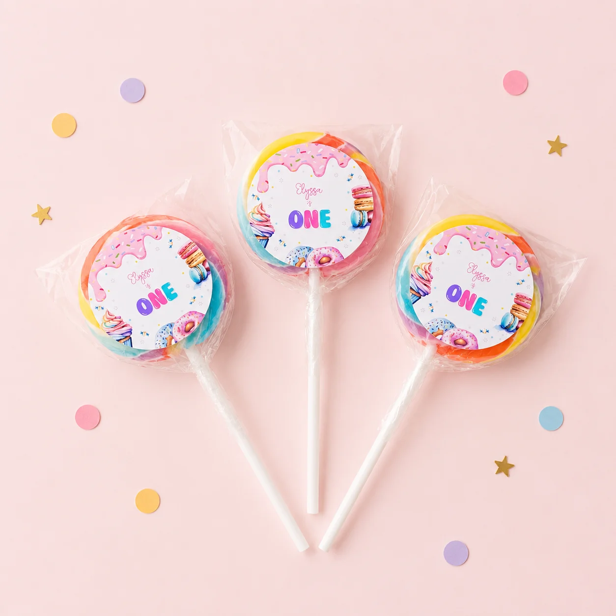 Candy Land personalised lollipops party favours with swirly lollipops and pastel sweet 1st birthday labels