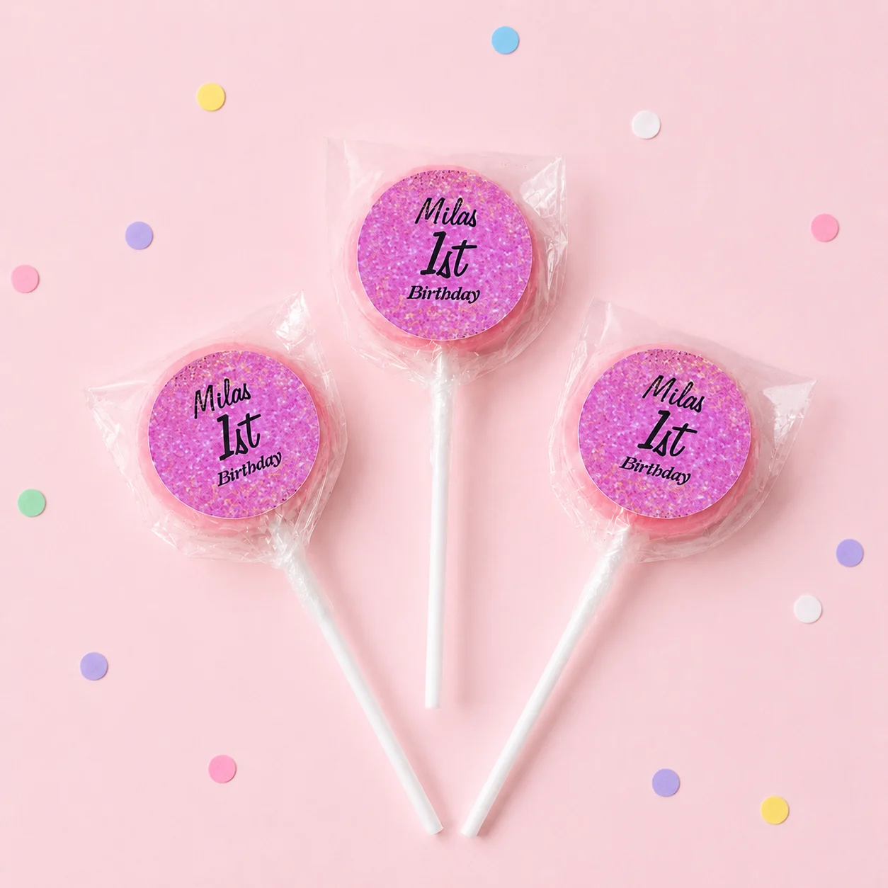 Glitter Milestone Birthday personalised lollipops party favours with swirly lollipops and pink 1st birthday labels