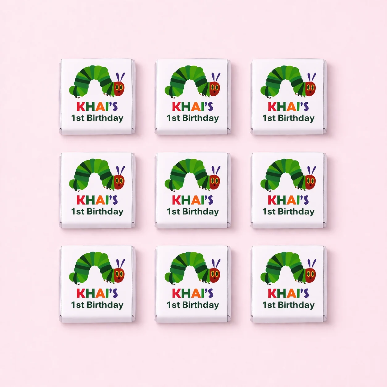 Hungry Caterpillar inspired personalised mini chocolates party favours with colourful 1st birthday wrappers