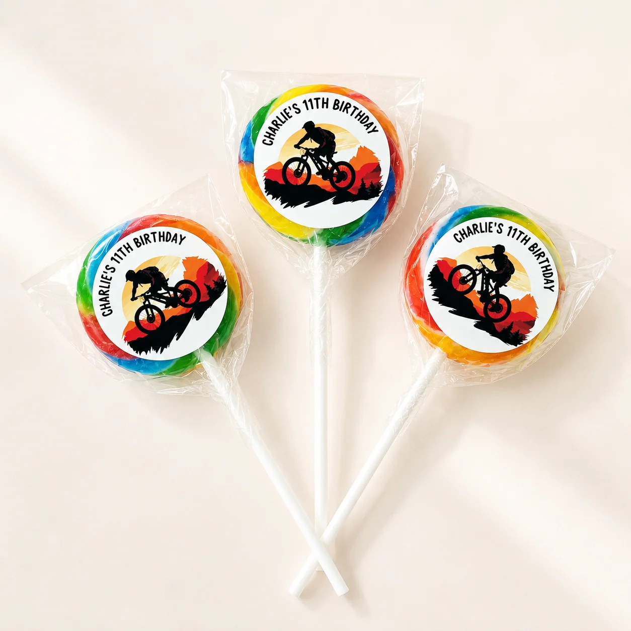 Mountain Bike personalised lollipops party favours with swirly lollipops and cycling birthday labels
