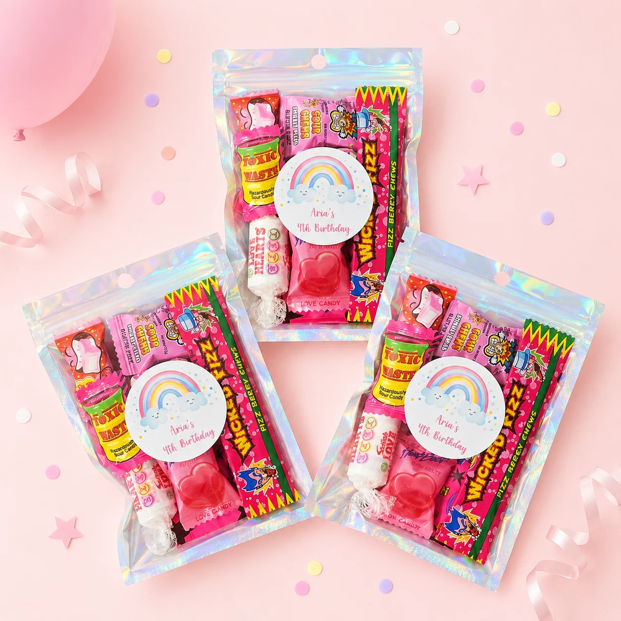 Rainbow personalised lolly bags prefilled with assorted lollies and custom pastel rainbow labels for a 4th birthday