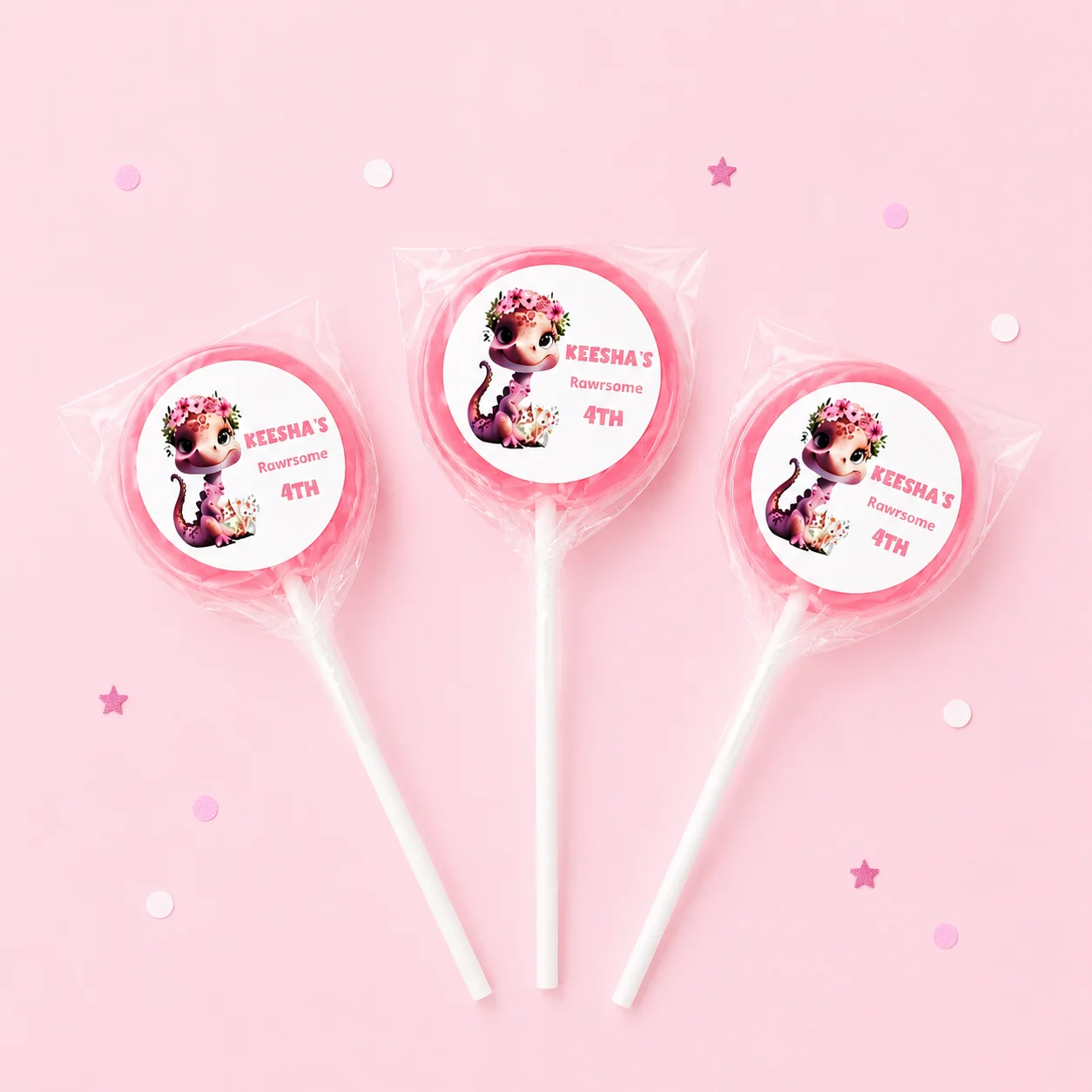 Pink Dino personalised lollipops party favours with swirly lollipops and cute dinosaur birthday labels