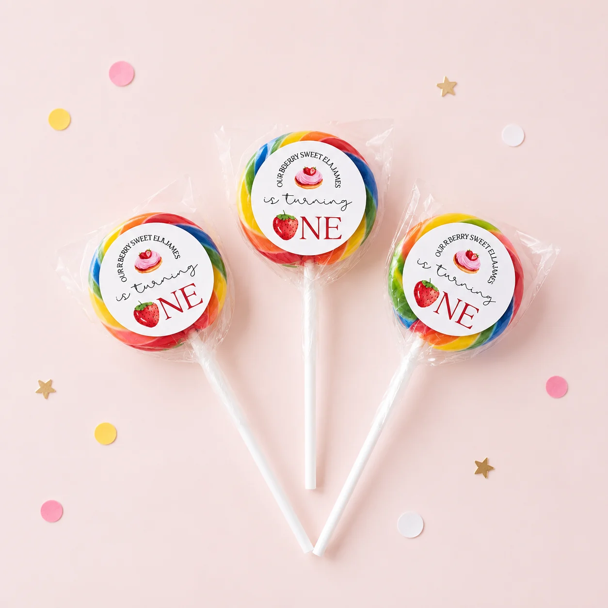 Strawberry personalised lollipops party favours with swirly lollipops and berry sweet 1st birthday labels