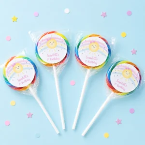 Sunshine Rainbow personalised lollipops party favours with swirly lollipops and smiling sun 1st birthday labels