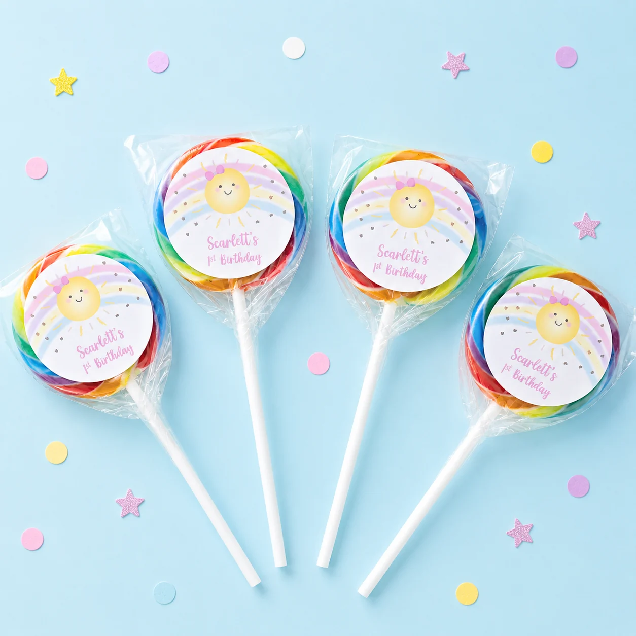 Sunshine Rainbow personalised lollipops party favours with swirly lollipops and smiling sun 1st birthday labels