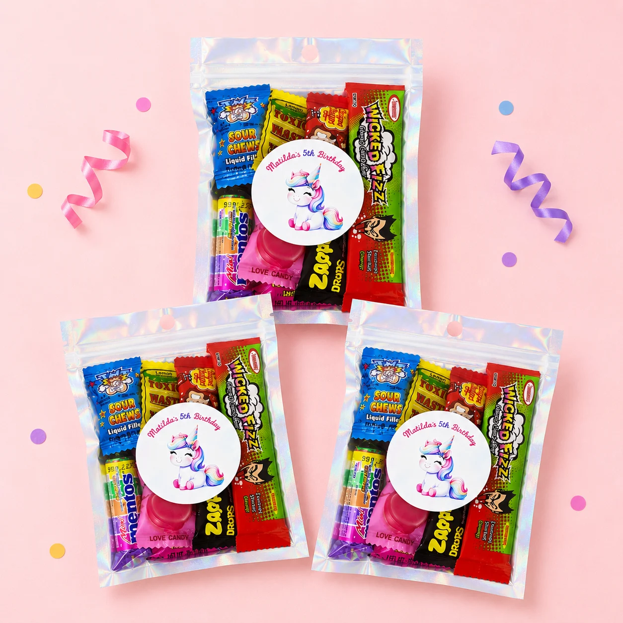 Unicorn personalised lolly bags prefilled with assorted lollies and finished with custom rainbow unicorn labels for birthday
