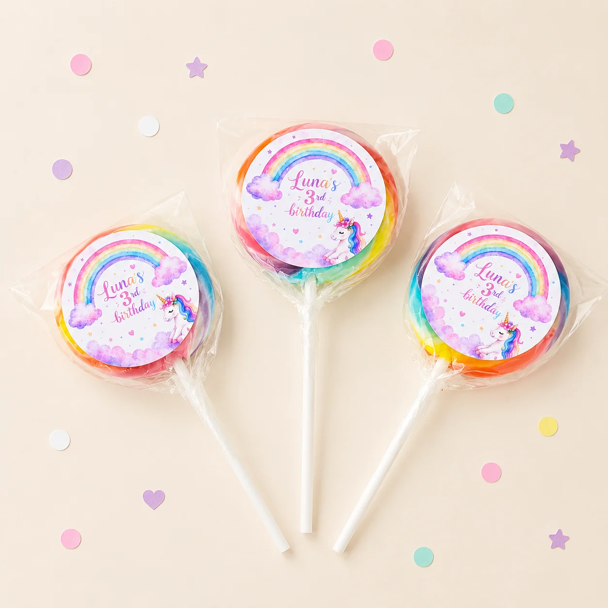 Unicorn personalised lollipops party favours with swirly lollipops and pastel unicorn birthday labels